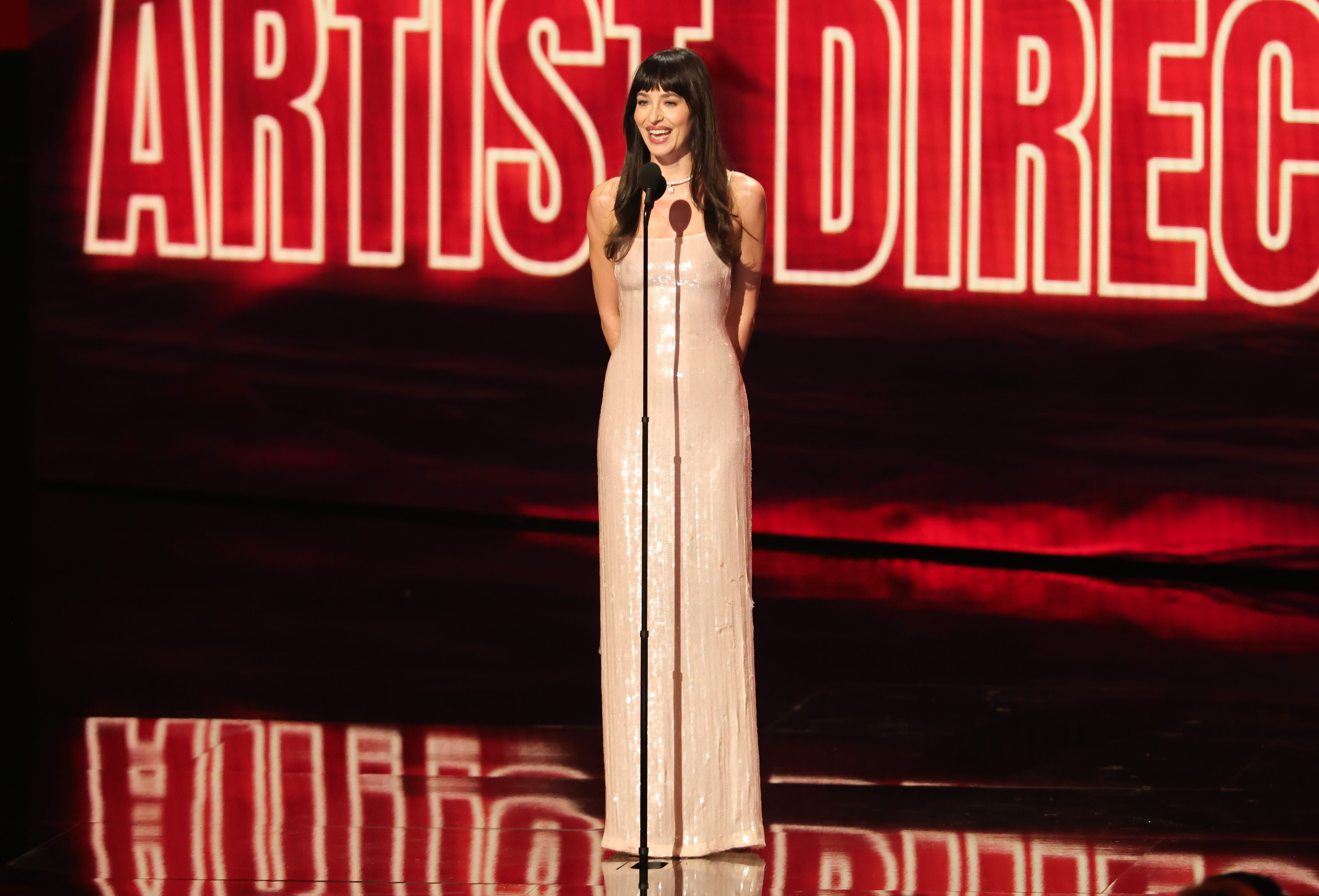 Dakota Johnson Wears a Liquid White Gown to Present Taylor Swift the First-Ever Artist Director Honor at the VMAs